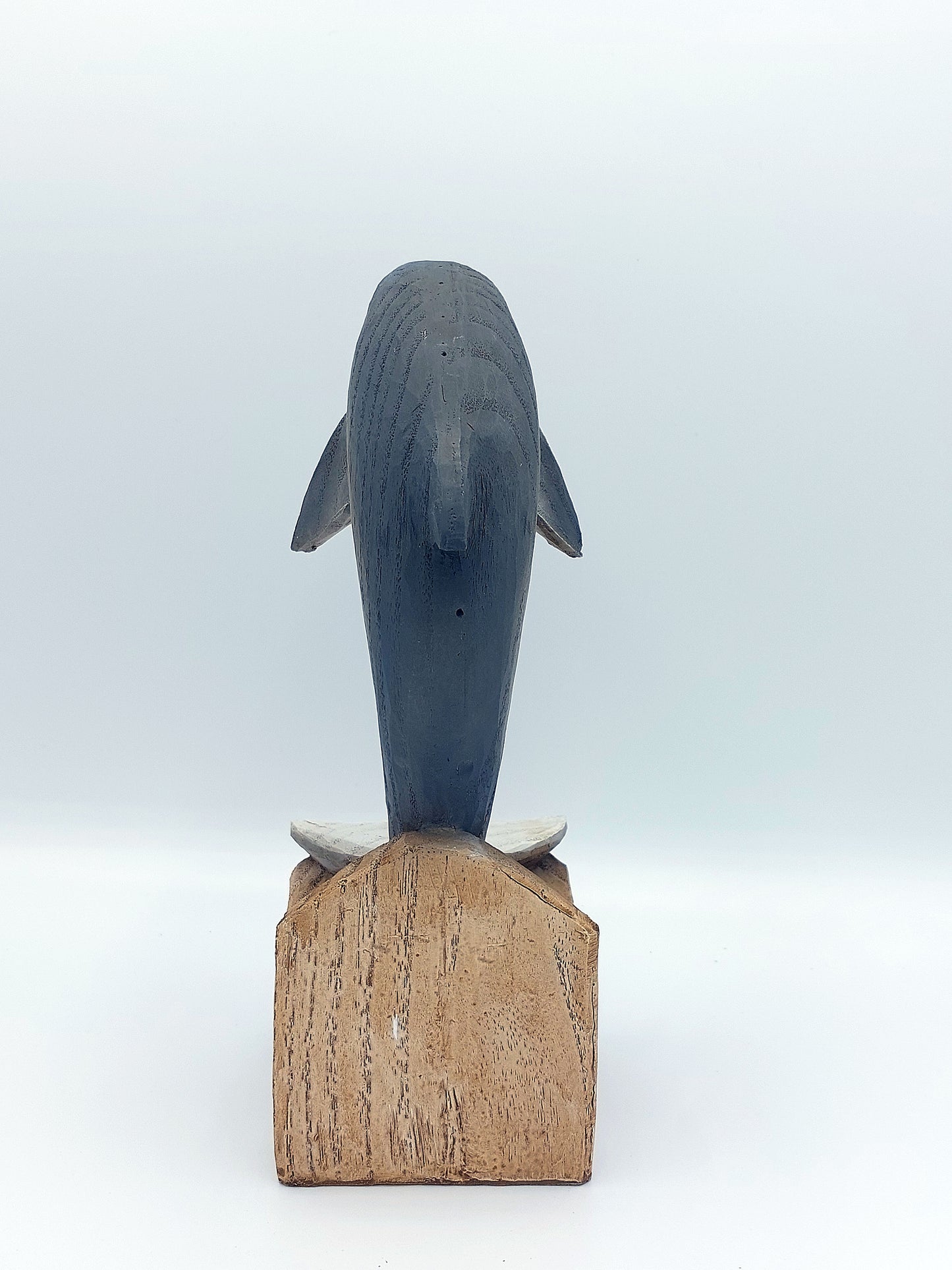 Driftwood look ceramic Dolphin an a base